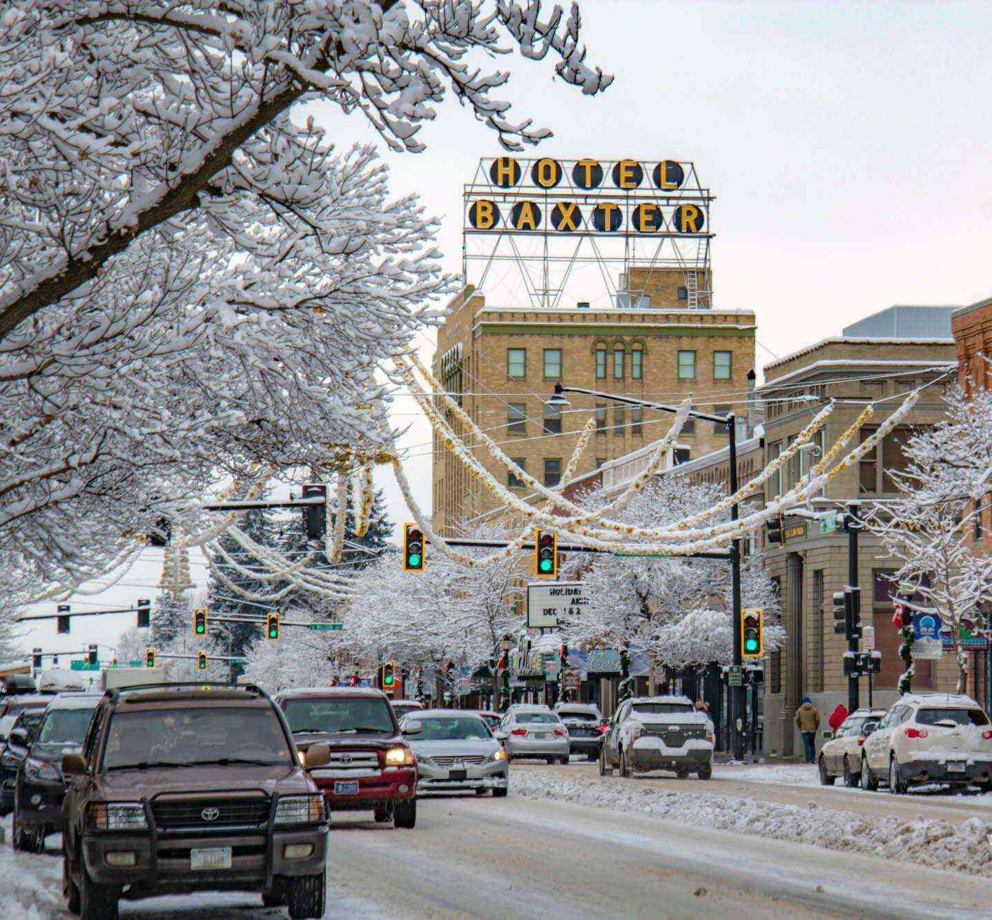 "Downtown Bozeman, Montana decorated with festive holiday lights and storefront decorations, capturing the spirit of Christmas in the Gallatin Valley."